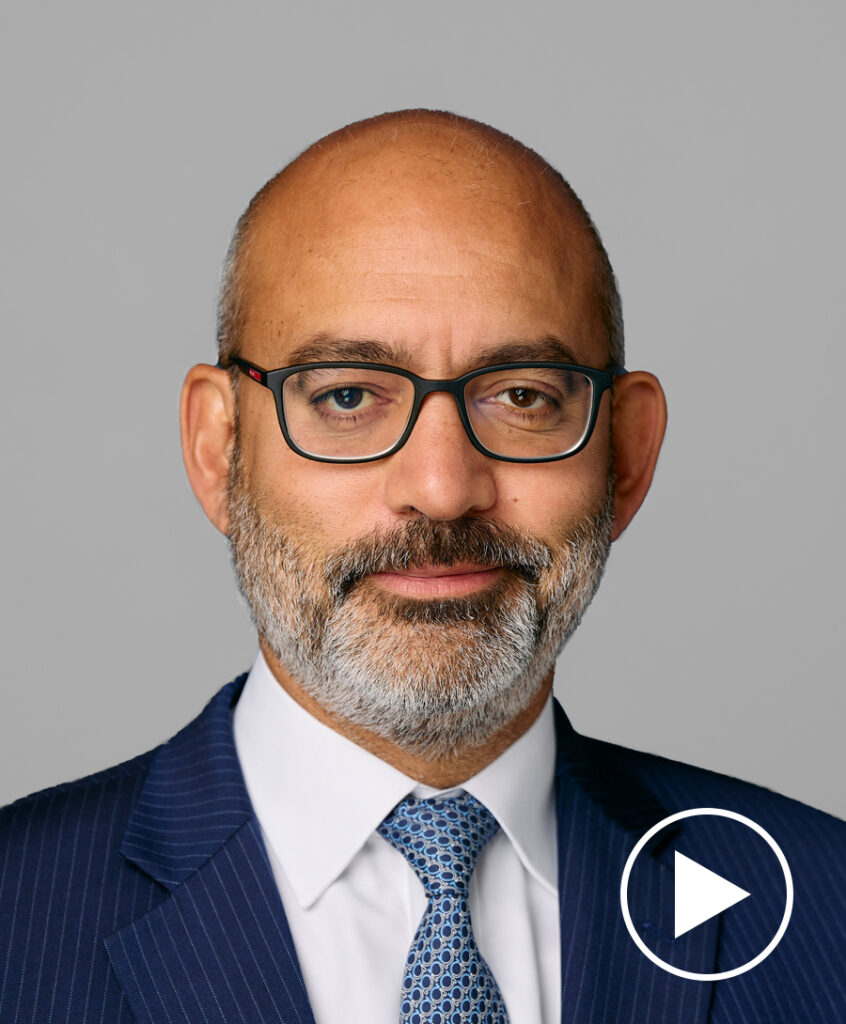 Photo of Krishna Guha with play button