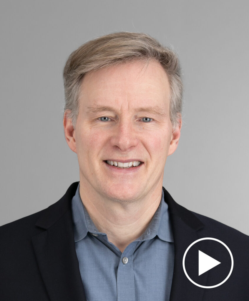 Photo of Mark Mahaney with play button