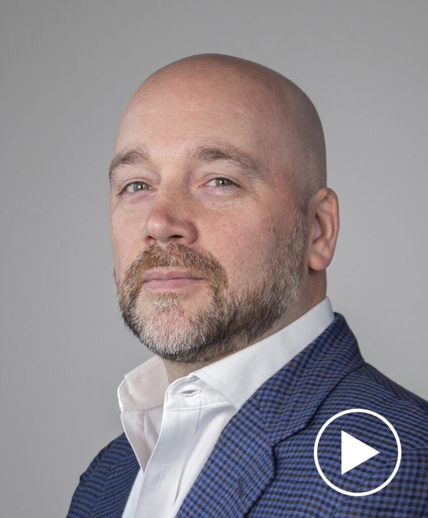 Photo of Chris McNally with play button